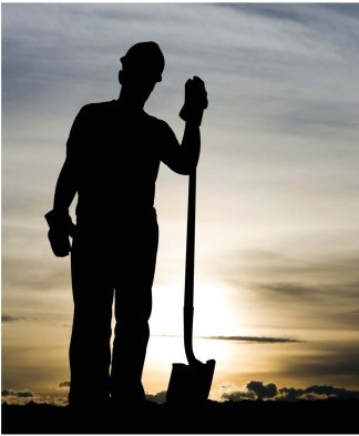 worker with hardhat shovel sunrise